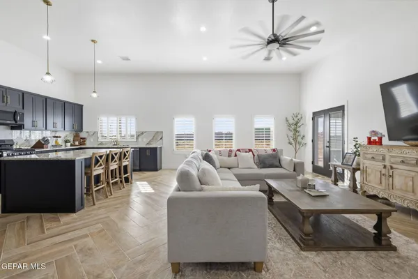 a living room with furniture kitchen and a chandelier