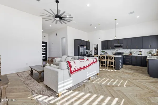 a living room with furniture a ceiling fan and a rug