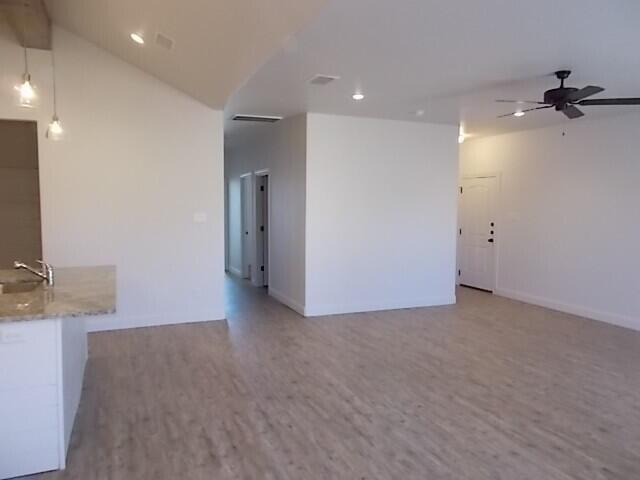 2002 102nd Street, Unit B Lubbock, TX 79423 - Photo 15 of 17 an empty room with a fireplace and wooden floor