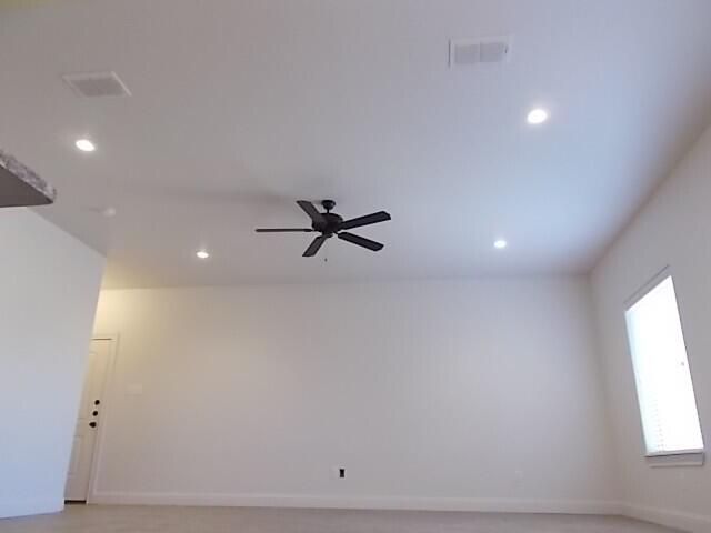 2002 102nd Street, Unit B Lubbock, TX 79423 - Photo 16 of 17 a view of a room with a window and a ceiling fan