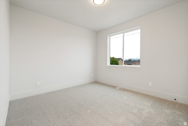 529 North Hvn Drive Mapleton, UT 84664 - Photo 27 of 30 Neutral-toned interior room featuring light gray carpeting and white baseboards