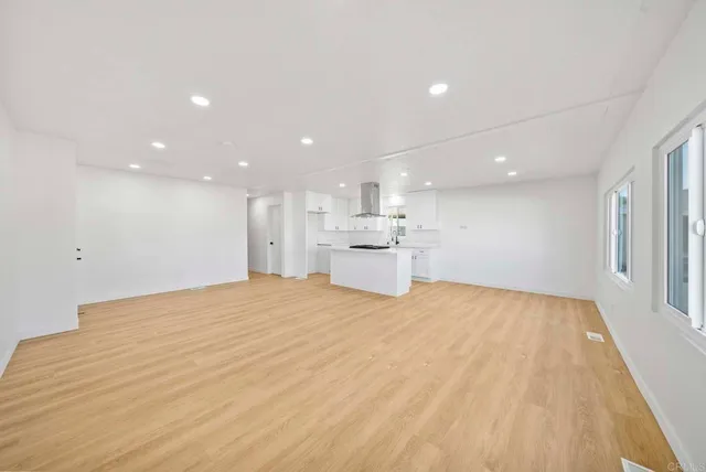 a view of an empty room with a kitchen