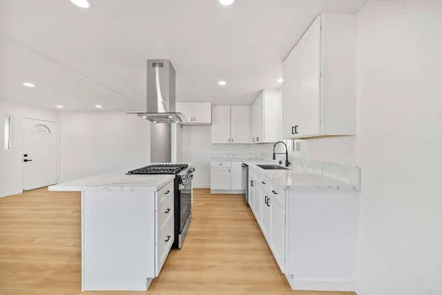 a kitchen with stainless steel appliances granite countertop a sink and cabinets