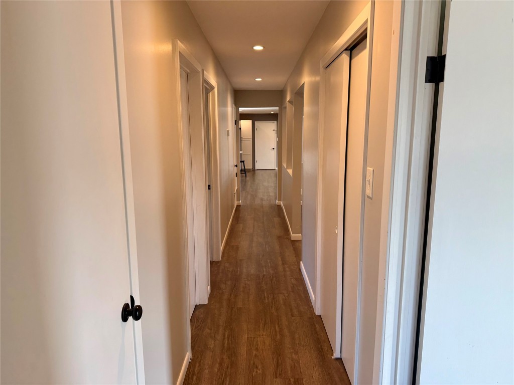 9712 Springdale Road Austin, TX 78754 - Photo 15 of 40 a view of a hallway with wooden floor and staircase