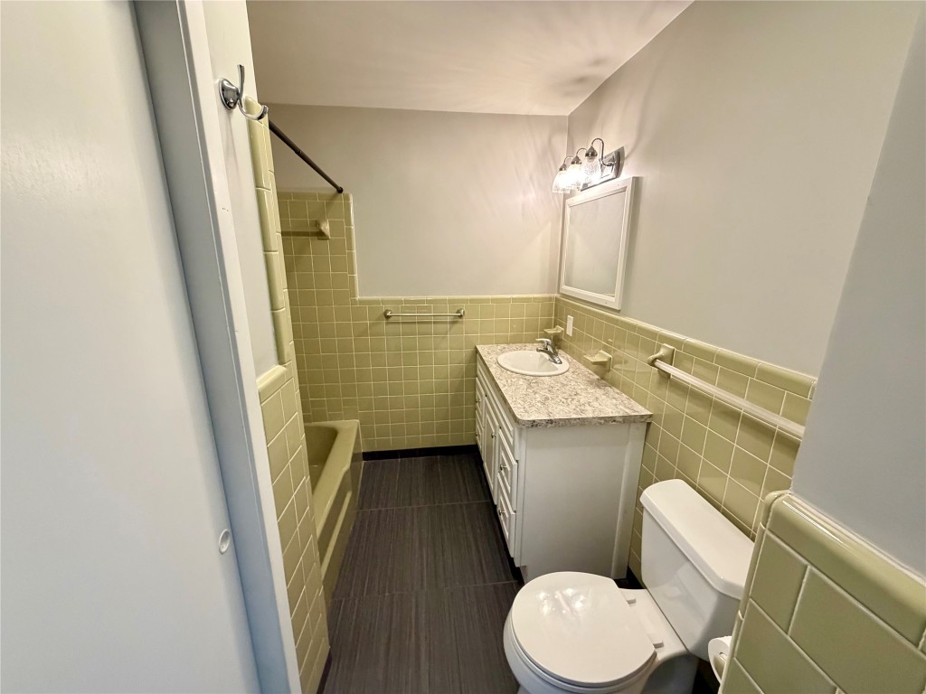 9712 Springdale Road Austin, TX 78754 - Photo 19 of 40 a bathroom with a sink a toilet a mirror and shower