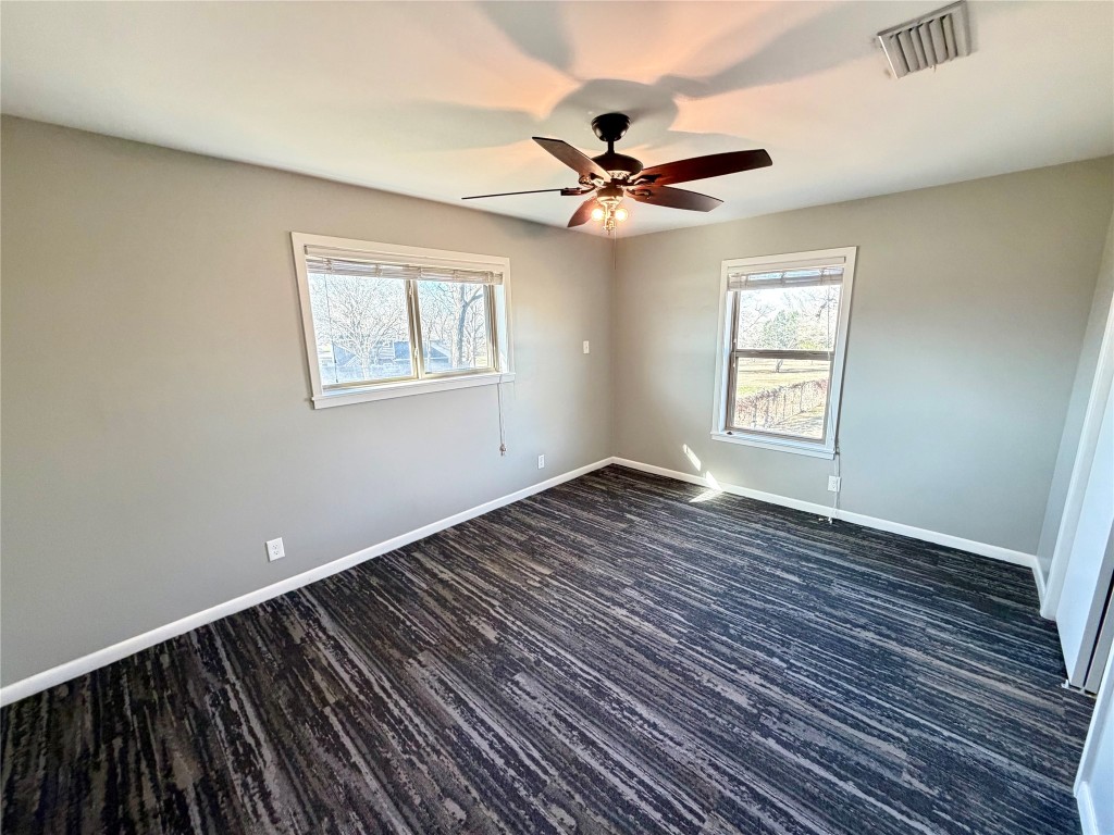 9712 Springdale Road Austin, TX 78754 - Photo 20 of 40 a view of empty room with wooden floor and fan