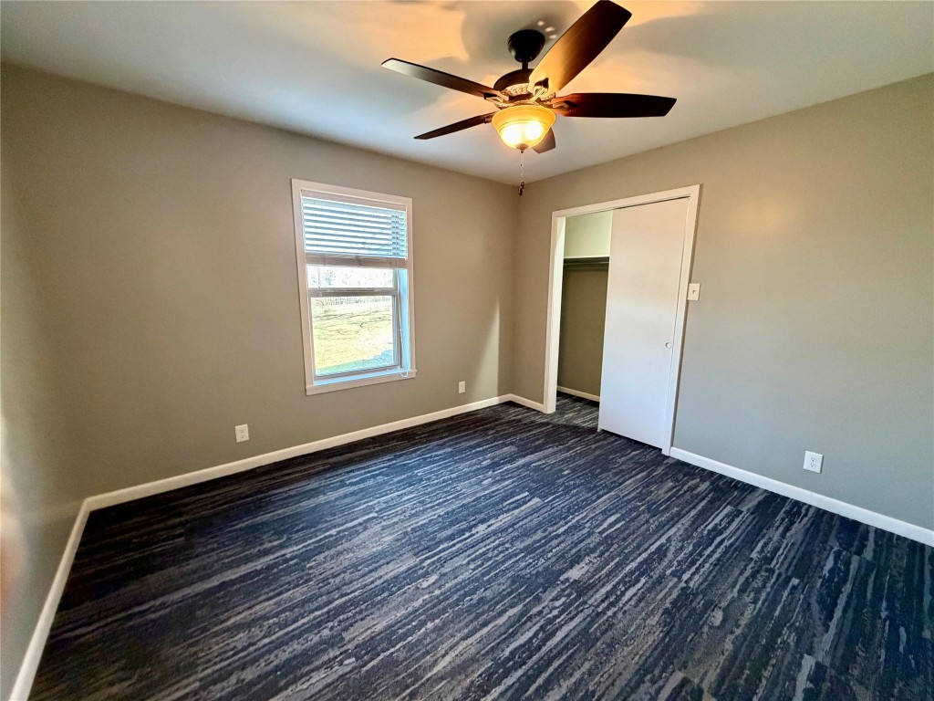 9712 Springdale Road Austin, TX 78754 - Photo 23 of 40 a view of an empty room with window and wooden floor