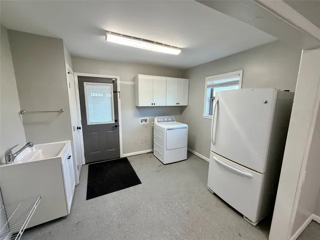 a kitchen with a refrigerator sink stove and cabinets