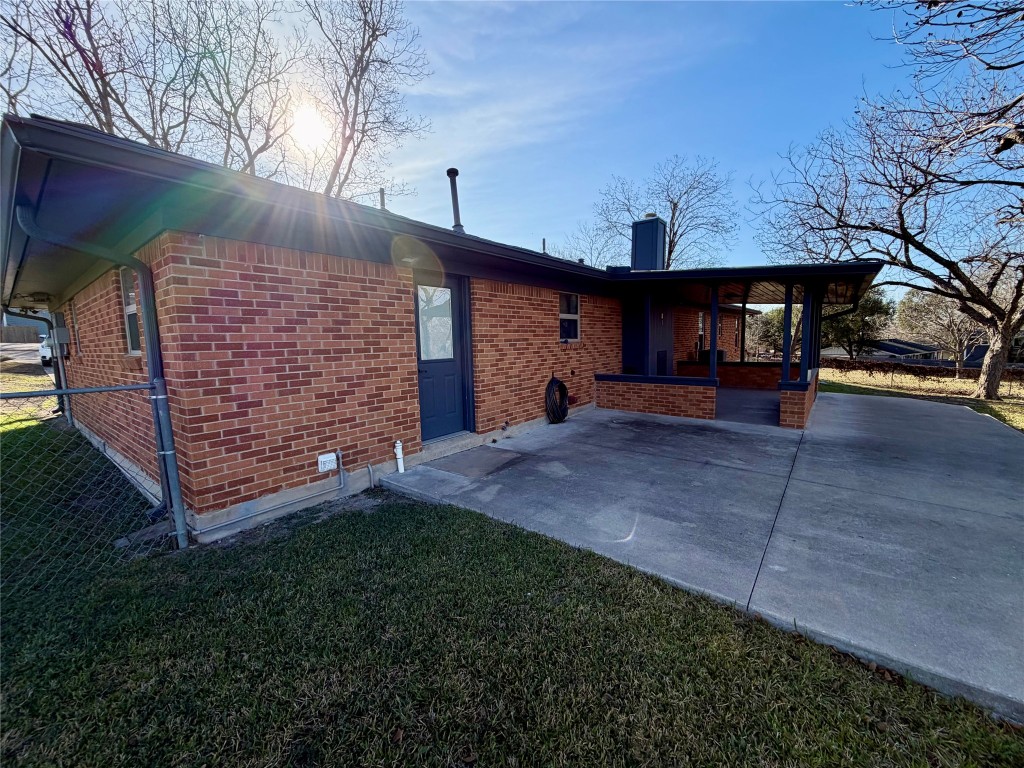 9712 Springdale Road Austin, TX 78754 - Photo 32 of 40 a view of a backyard with plants and a garage