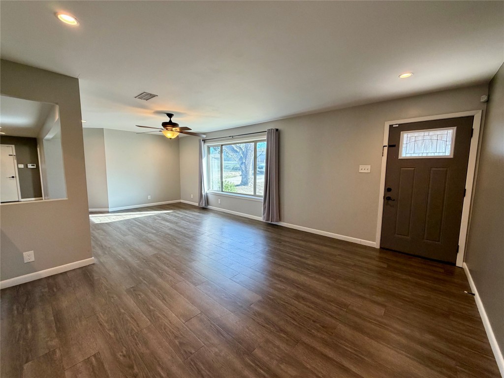 9712 Springdale Road Austin, TX 78754 - Photo 8 of 40 an empty room with wooden floor and windows