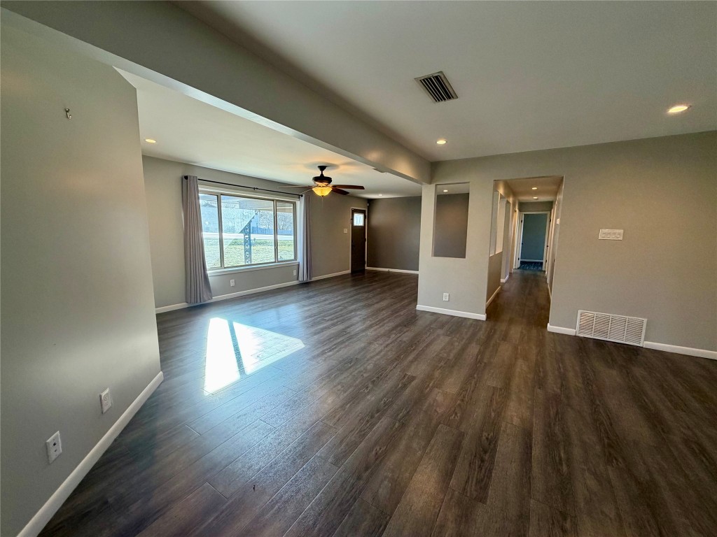 9712 Springdale Road Austin, TX 78754 - Photo 10 of 40 an empty room with wooden floor and windows