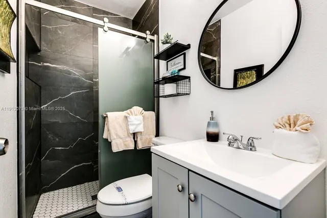 a bathroom with a sink mirror and toilet