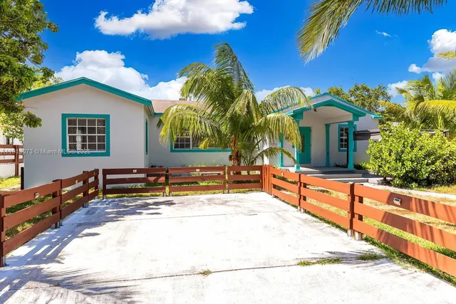 a view of a house with swimming pool and sitting area