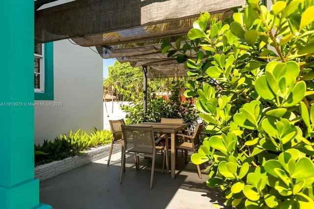a view of a patio with table and chairs and potted plants