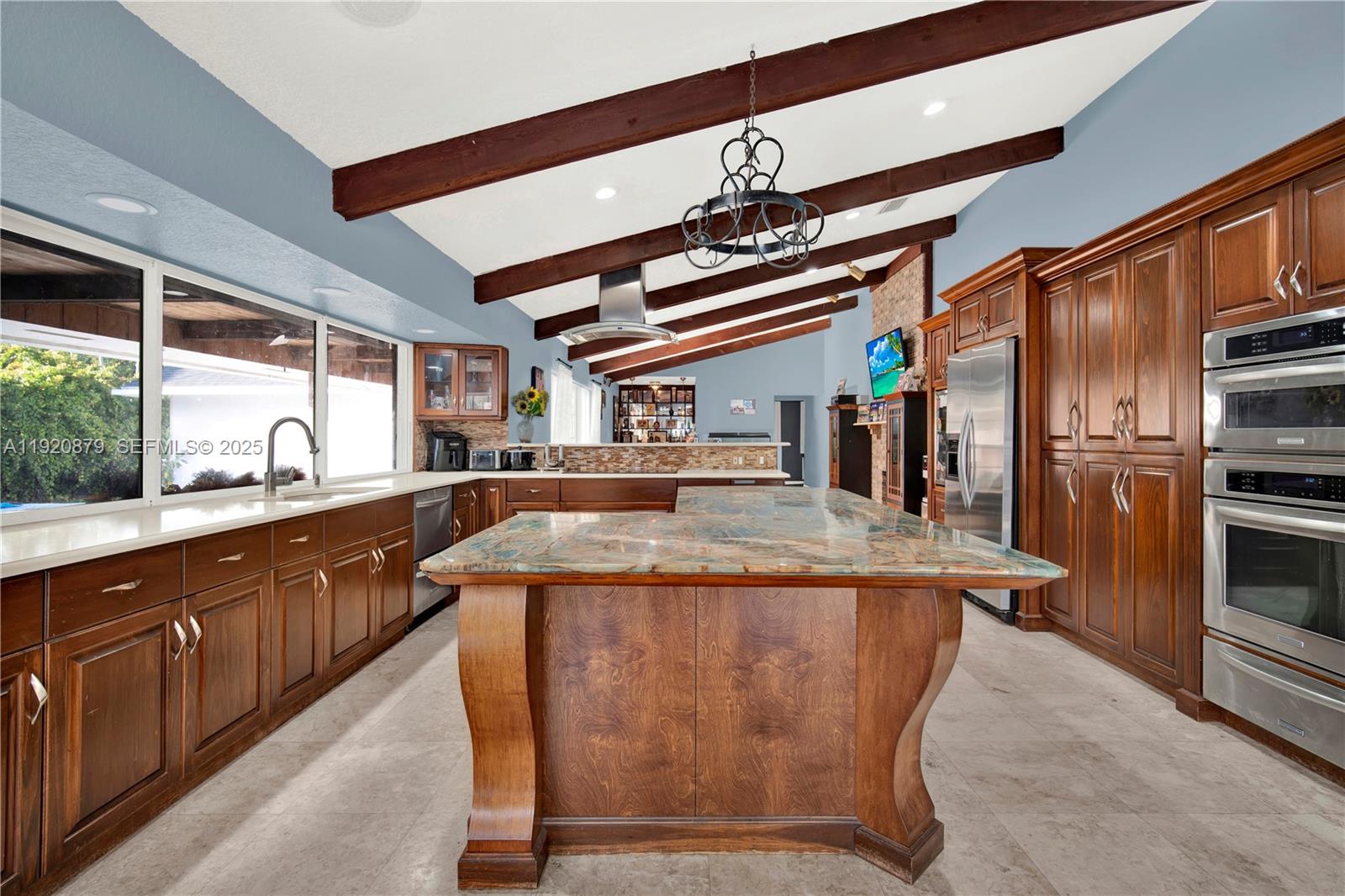 29472 Southwest 193rd Court Homestead, FL 33030 - Photo 17 of 44 a kitchen with stainless steel appliances granite countertop a sink and a refrigerator
