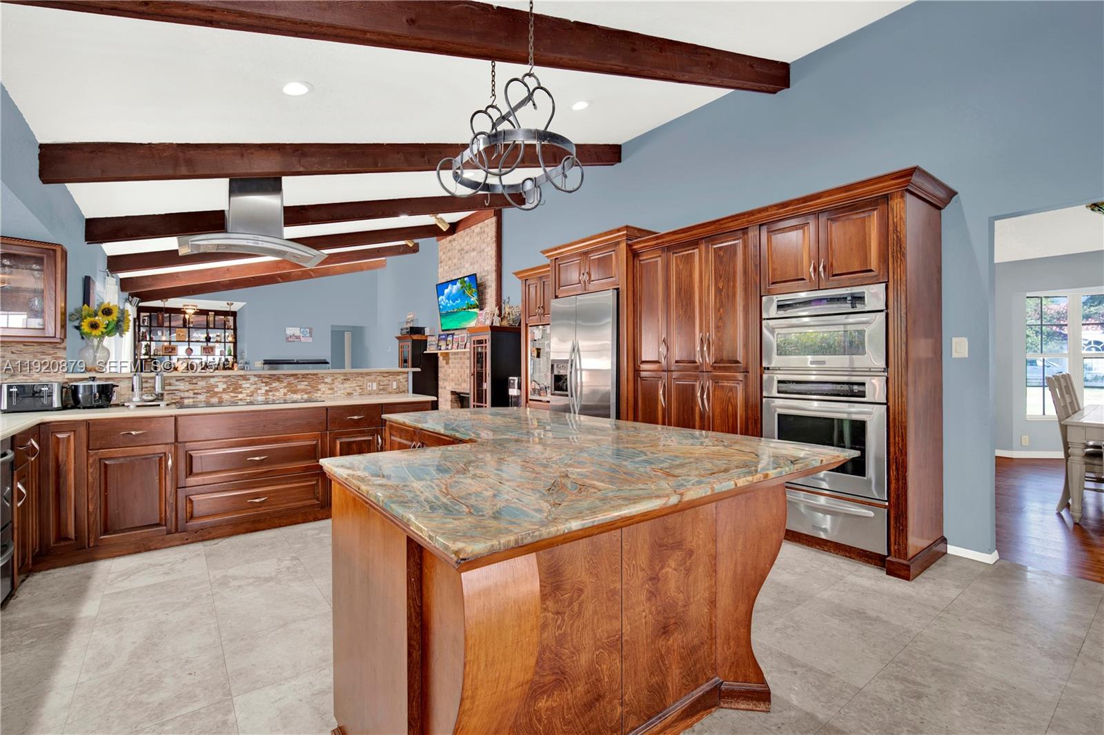 29472 Southwest 193rd Court Homestead, FL 33030 - Photo 22 of 44 a kitchen with stainless steel appliances granite countertop a stove and refrigerator