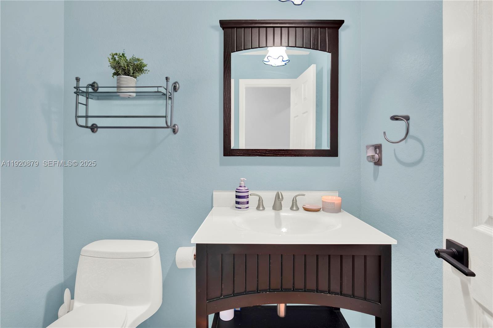 29472 Southwest 193rd Court Homestead, FL 33030 - Photo 23 of 44 a bathroom with a toilet sink and mirror