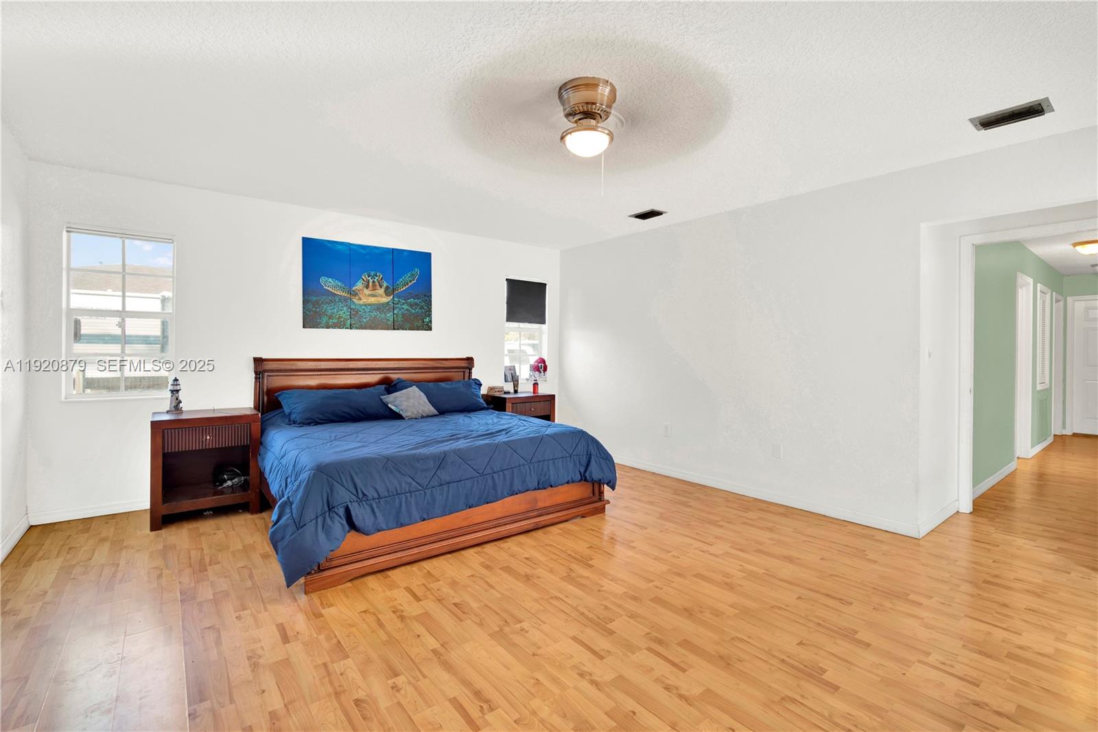 29472 Southwest 193rd Court Homestead, FL 33030 - Photo 28 of 44 a bedroom with a bed and painting on the wall