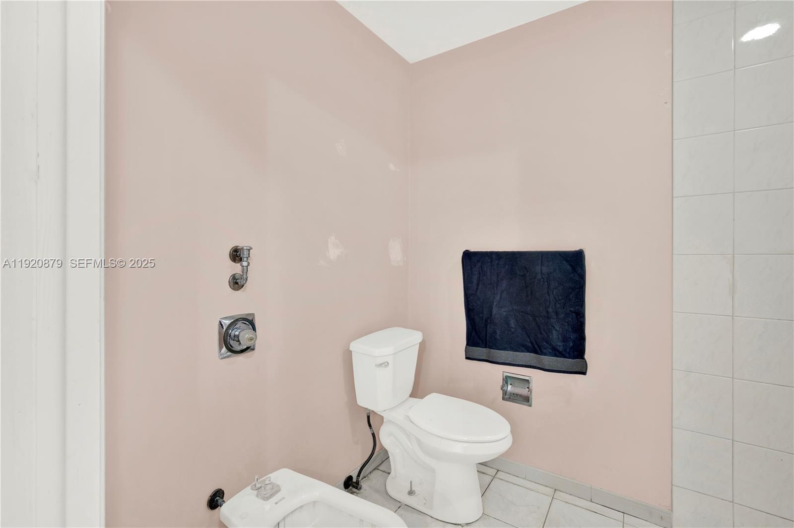 29472 Southwest 193rd Court Homestead, FL 33030 - Photo 33 of 44 a white toilet sitting next to a bathroom sink and a shower