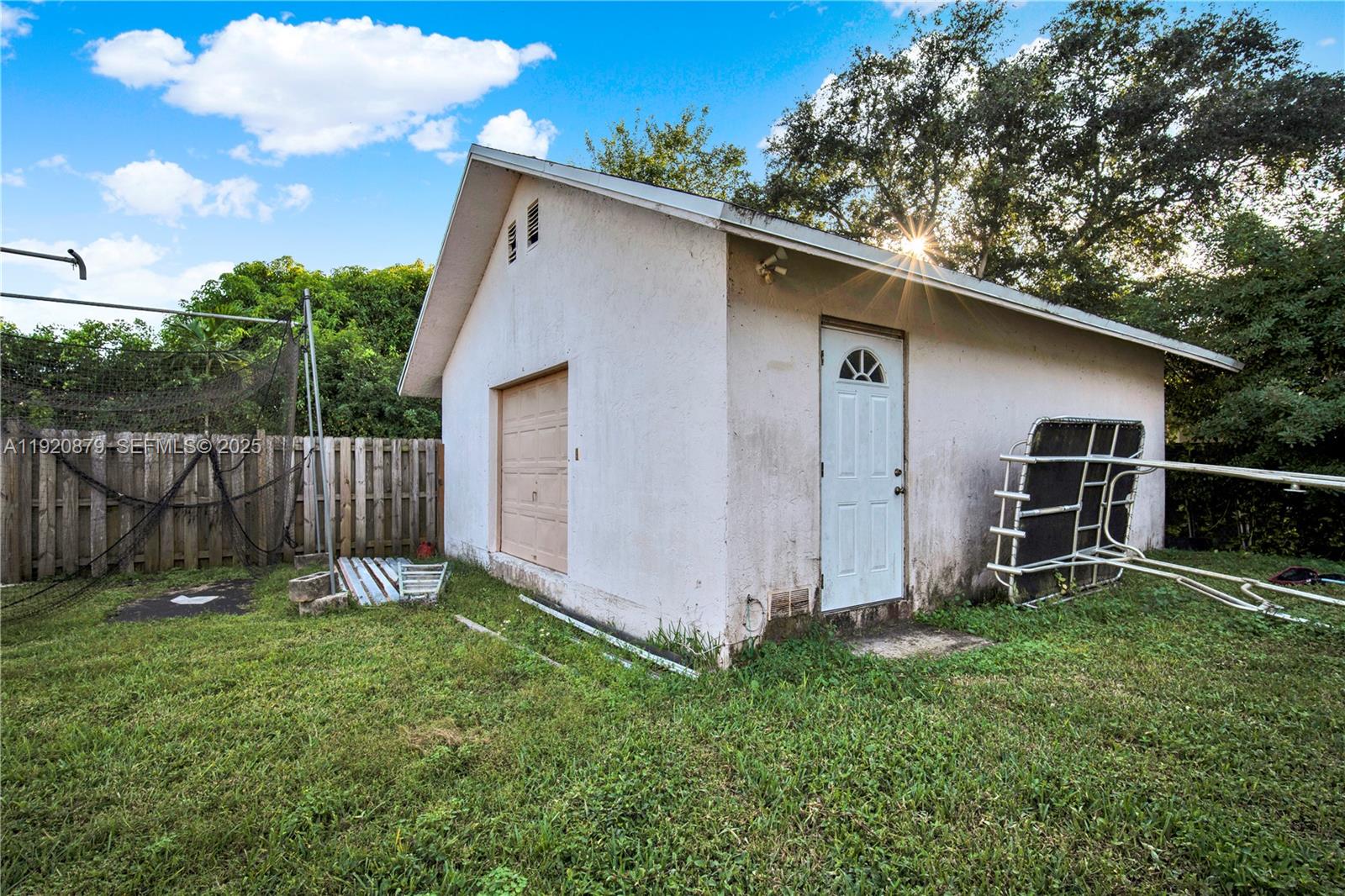 29472 Southwest 193rd Court Homestead, FL 33030 - Photo 40 of 44 a backyard of a house with a small barn and wooden fence
