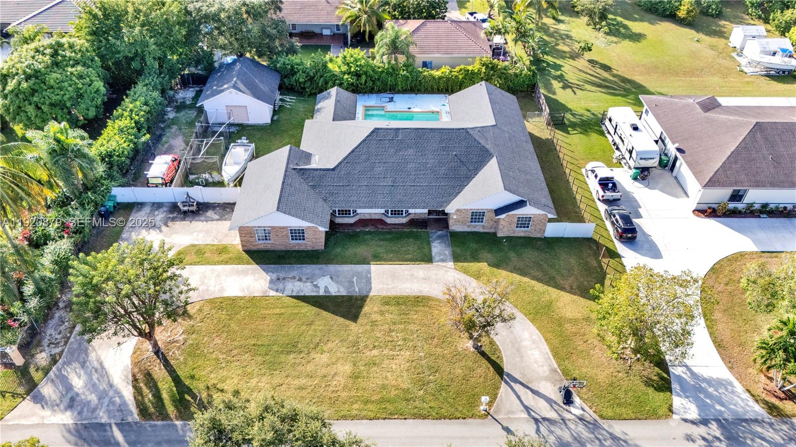 29472 Southwest 193rd Court Homestead, FL 33030 - Photo 41 of 44 a aerial view of a house with swimming pool and large trees