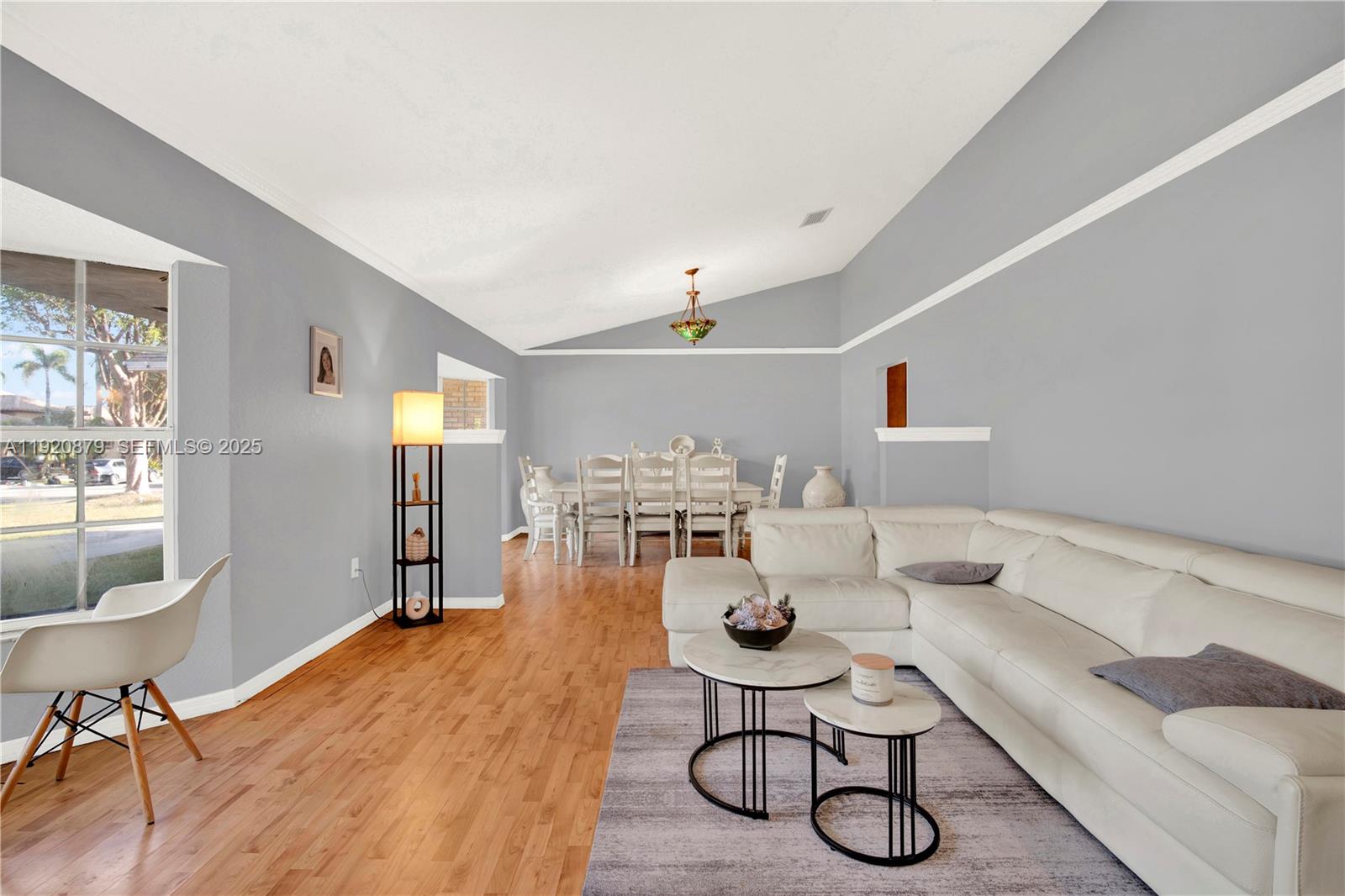 29472 Southwest 193rd Court Homestead, FL 33030 - Photo 6 of 44 a living room with furniture and a dining table with wooden floor