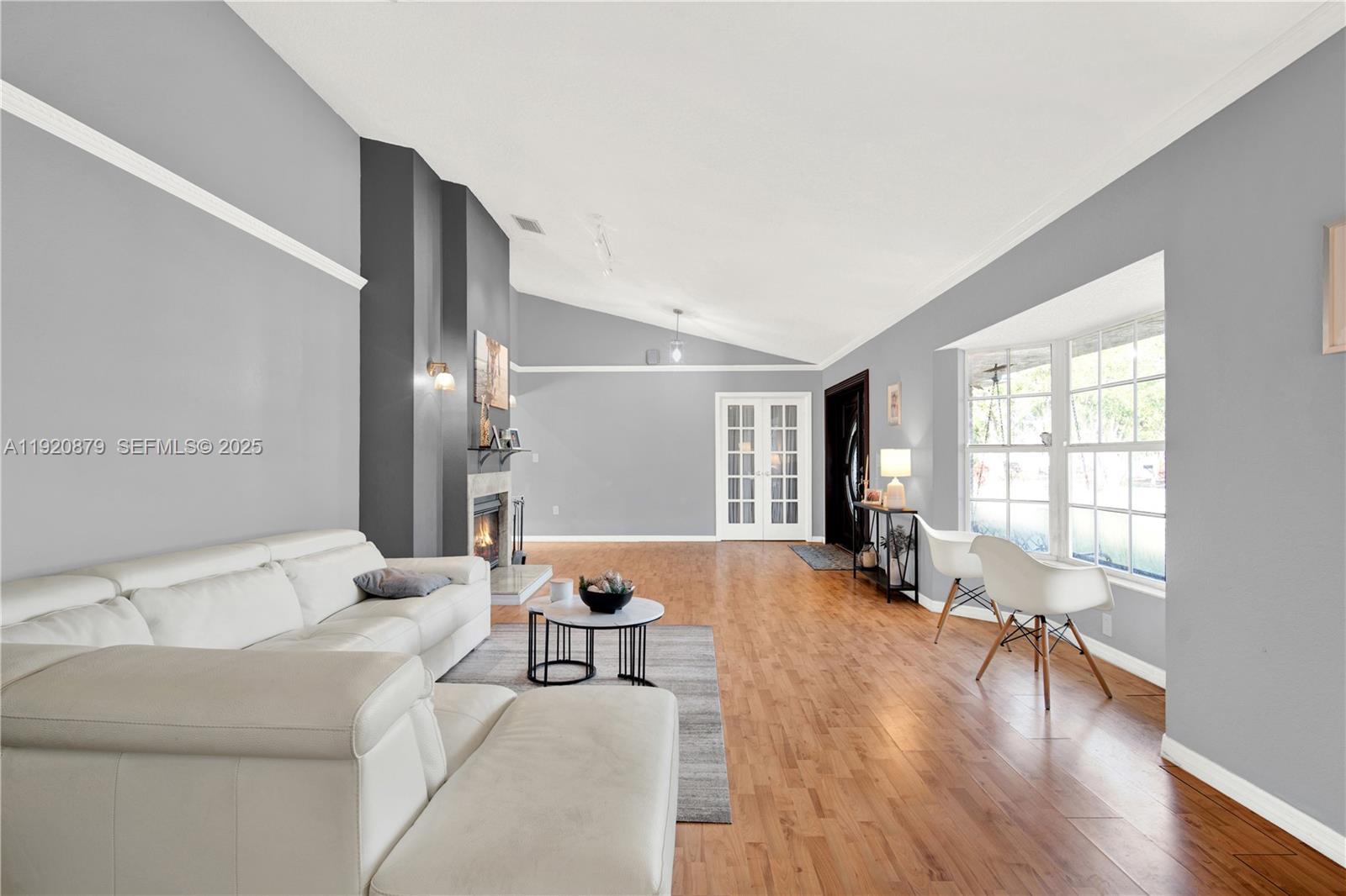 29472 Southwest 193rd Court Homestead, FL 33030 - Photo 8 of 44 a large white room with a large window and wooden floor