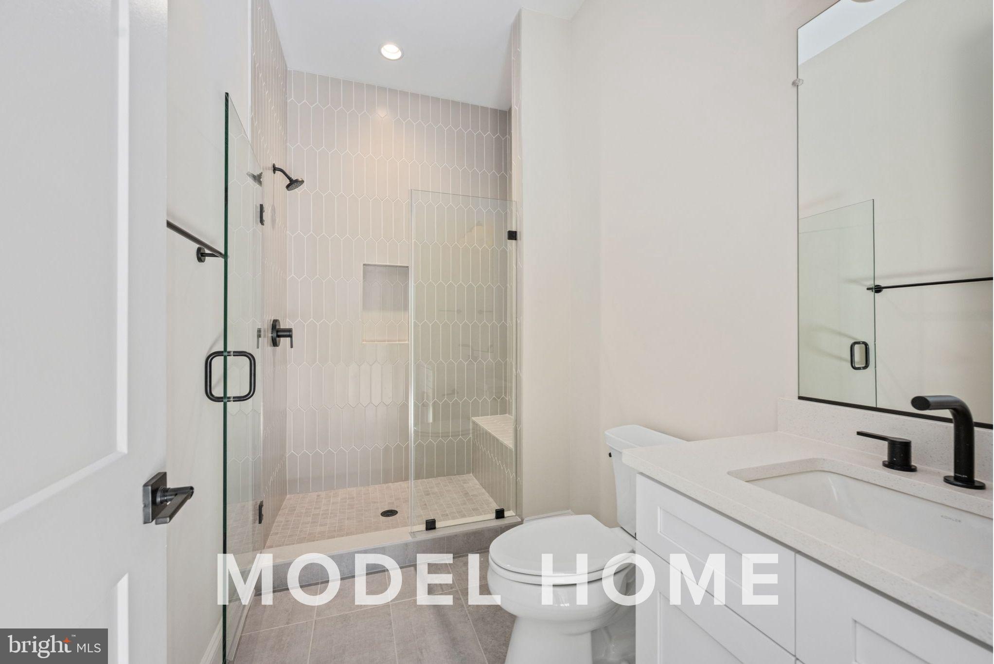 1901 Ware Road Falls Church, VA 22043 - Photo 13 of 39 a bathroom with a granite countertop sink a toilet and shower