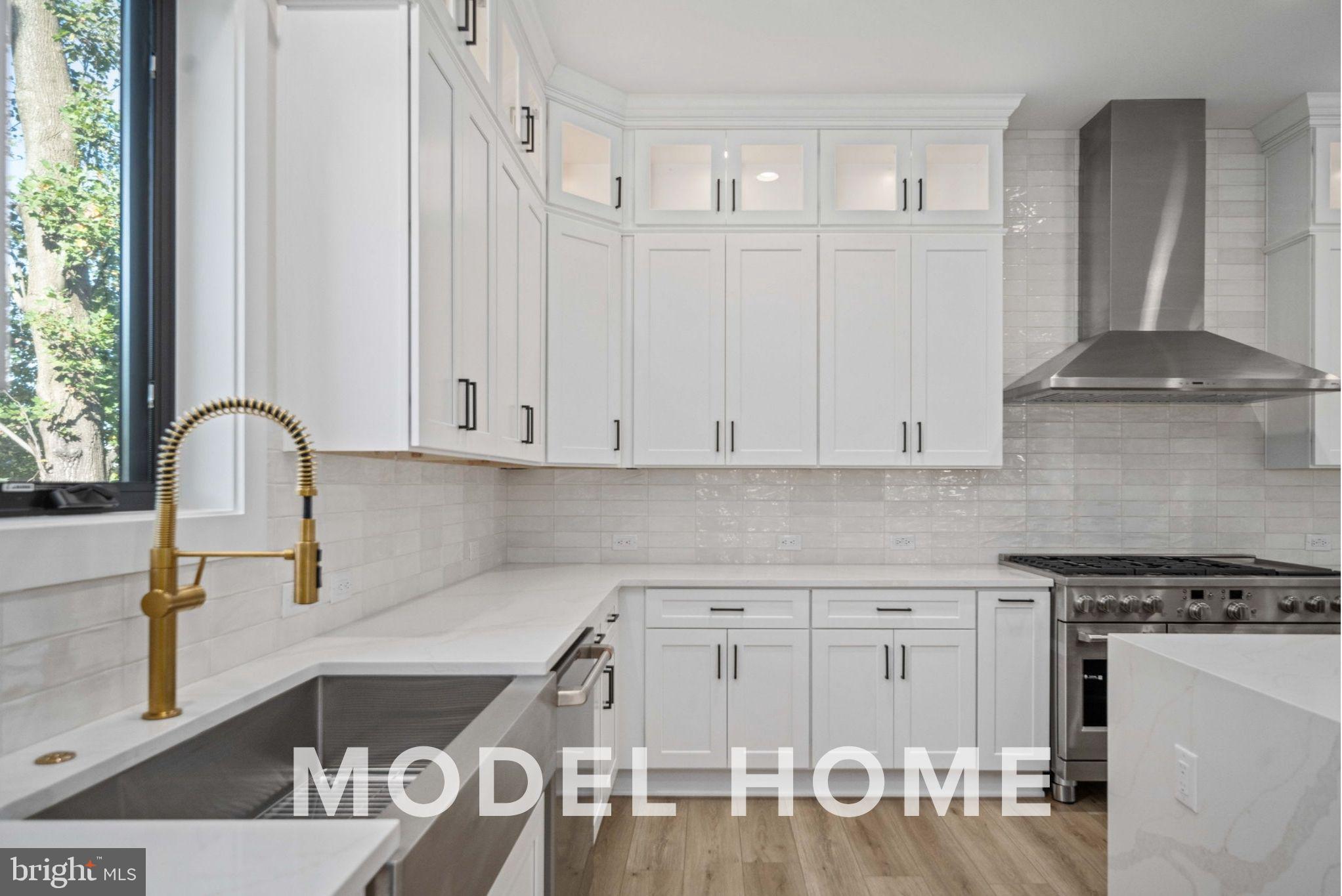 1901 Ware Road Falls Church, VA 22043 - Photo 16 of 39 a kitchen with granite countertop a stove and white cabinets
