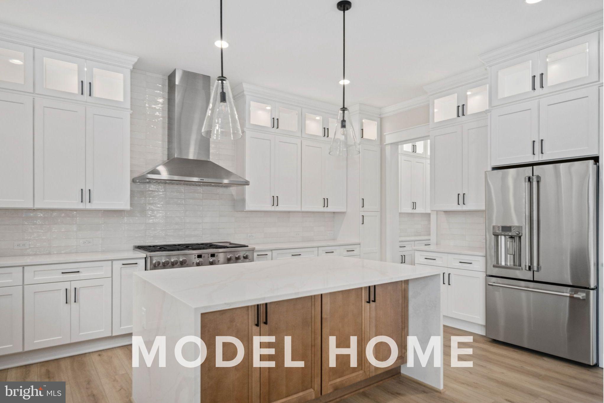 1901 Ware Road Falls Church, VA 22043 - Photo 17 of 39 a kitchen with stainless steel appliances granite countertop a sink a stove a refrigerator and white cabinets