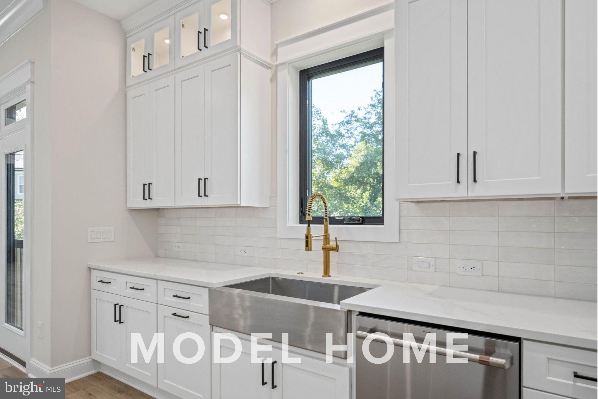 1901 Ware Road Falls Church, VA 22043 - Photo 22 of 39 a kitchen with stainless steel appliances a sink a stove and white cabinets