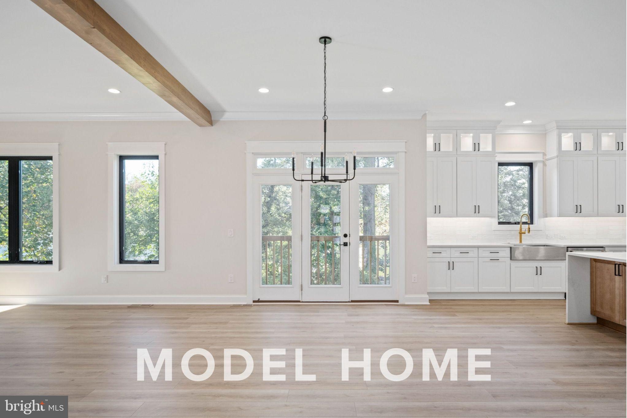 1901 Ware Road Falls Church, VA 22043 - Photo 23 of 39 a view of a kitchen with kitchen island a window wooden floor and stainless steel appliances