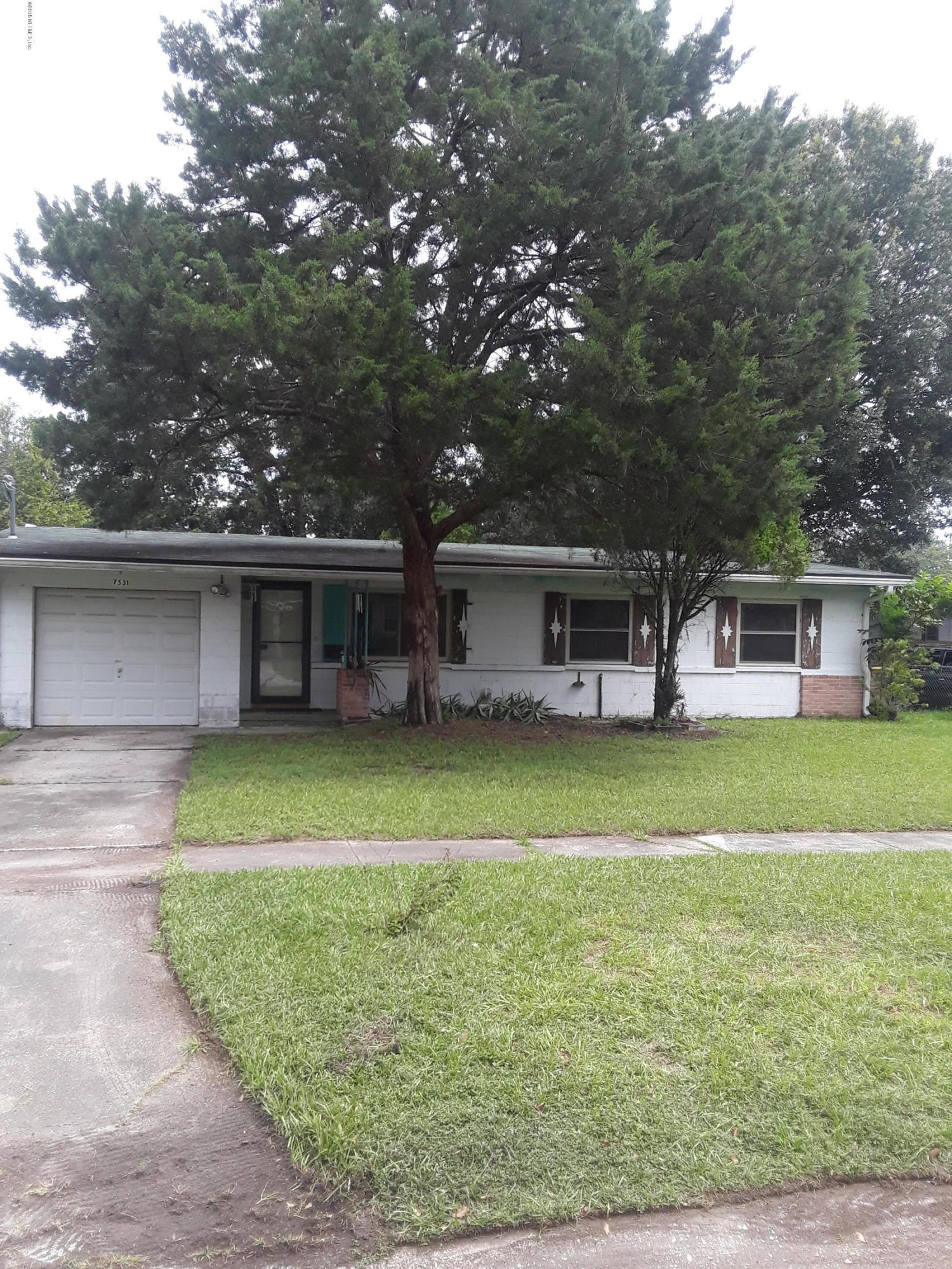 7531 Strato Road Jacksonville, FL 32210 - Photo 1 of 5 a front view of a house with a garden and trees