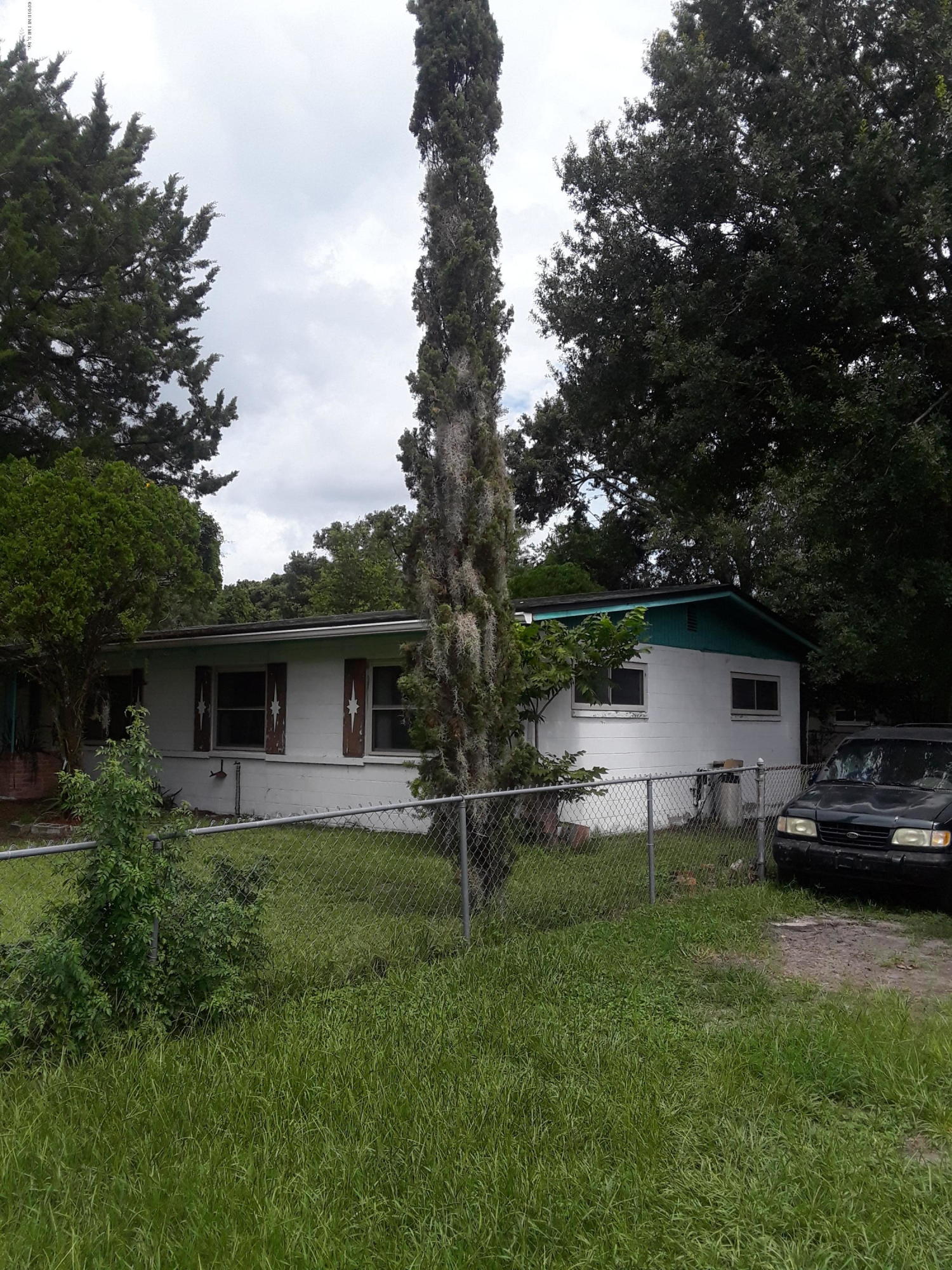 7531 Strato Road Jacksonville, FL 32210 - Photo 5 of 5 a view of a backyard with table and chairs and a large tree