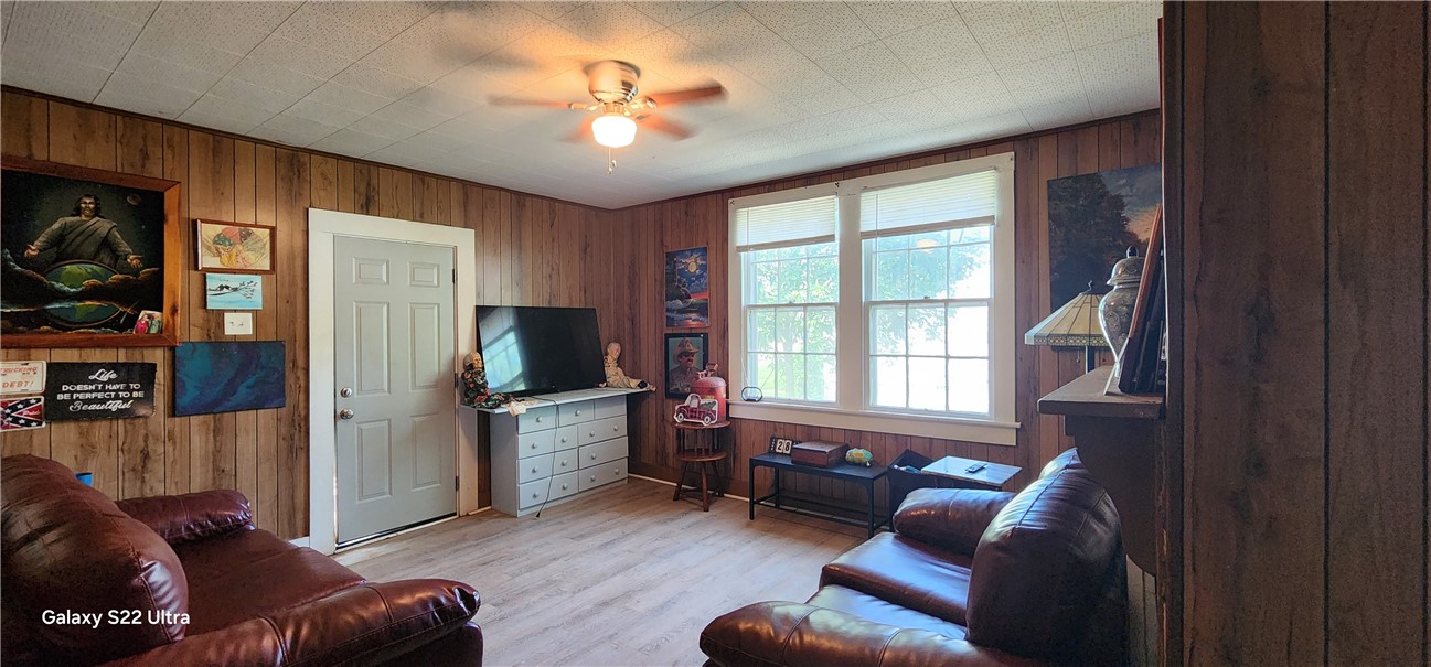 105 Hope Avenue Seneca, SC 29678 - Photo 7 of 33 A relaxed living space with warm wood paneling and abundant natural light.