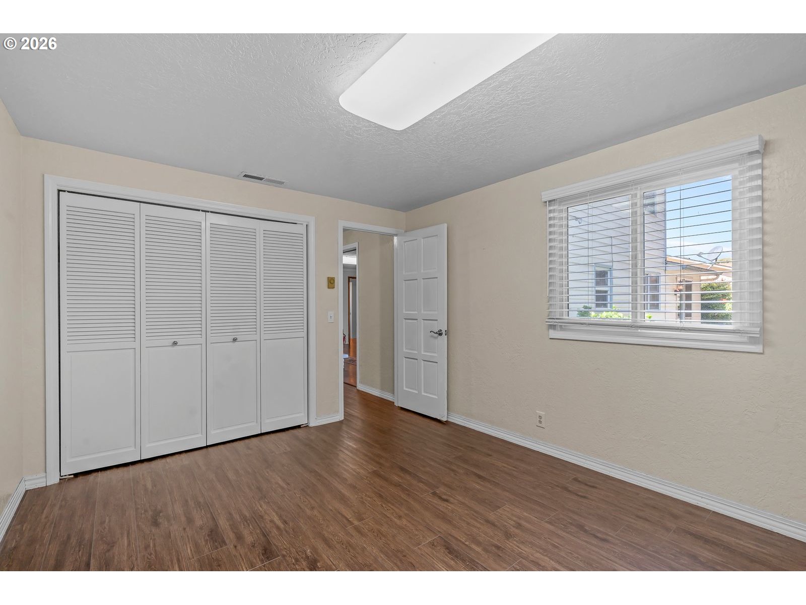 5356 Verda Lane Northeast Keizer, OR 97303 - Photo 19 of 41 a view of an empty room with wooden floor and a window
