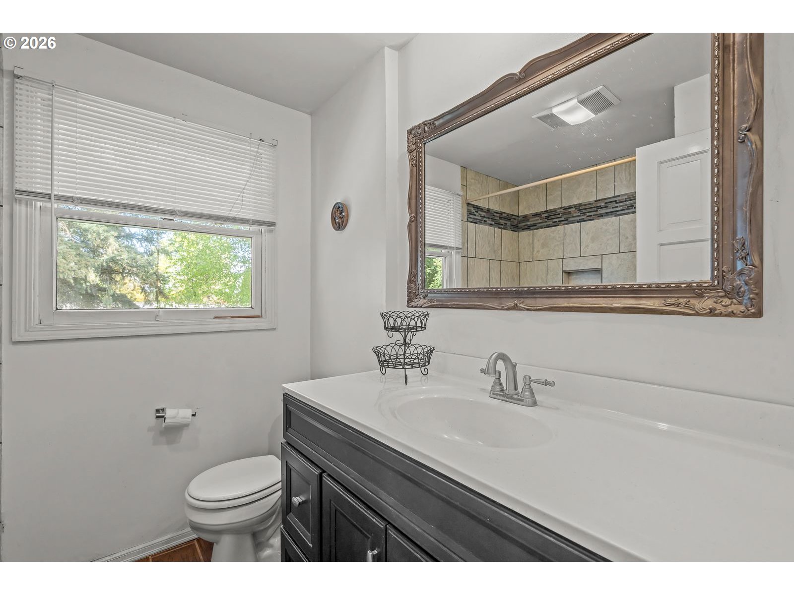 5356 Verda Lane Northeast Keizer, OR 97303 - Photo 29 of 41 a bathroom with a sink a toilet a mirror and a window