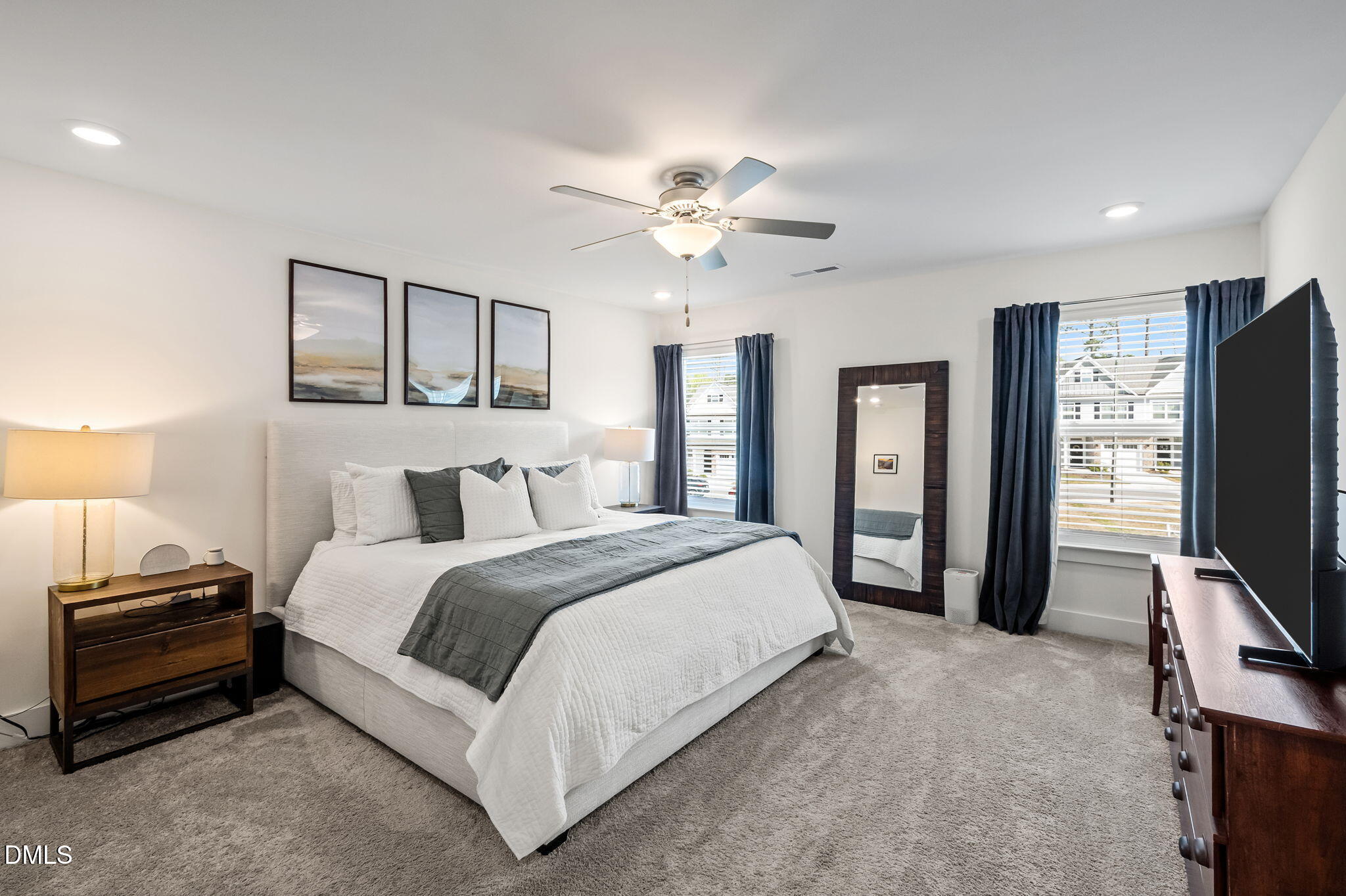 1000 Heartstone Way Durham, NC 27713 - Photo 5 of 43 a spacious bedroom with a bed and a flat tv screen on dresser