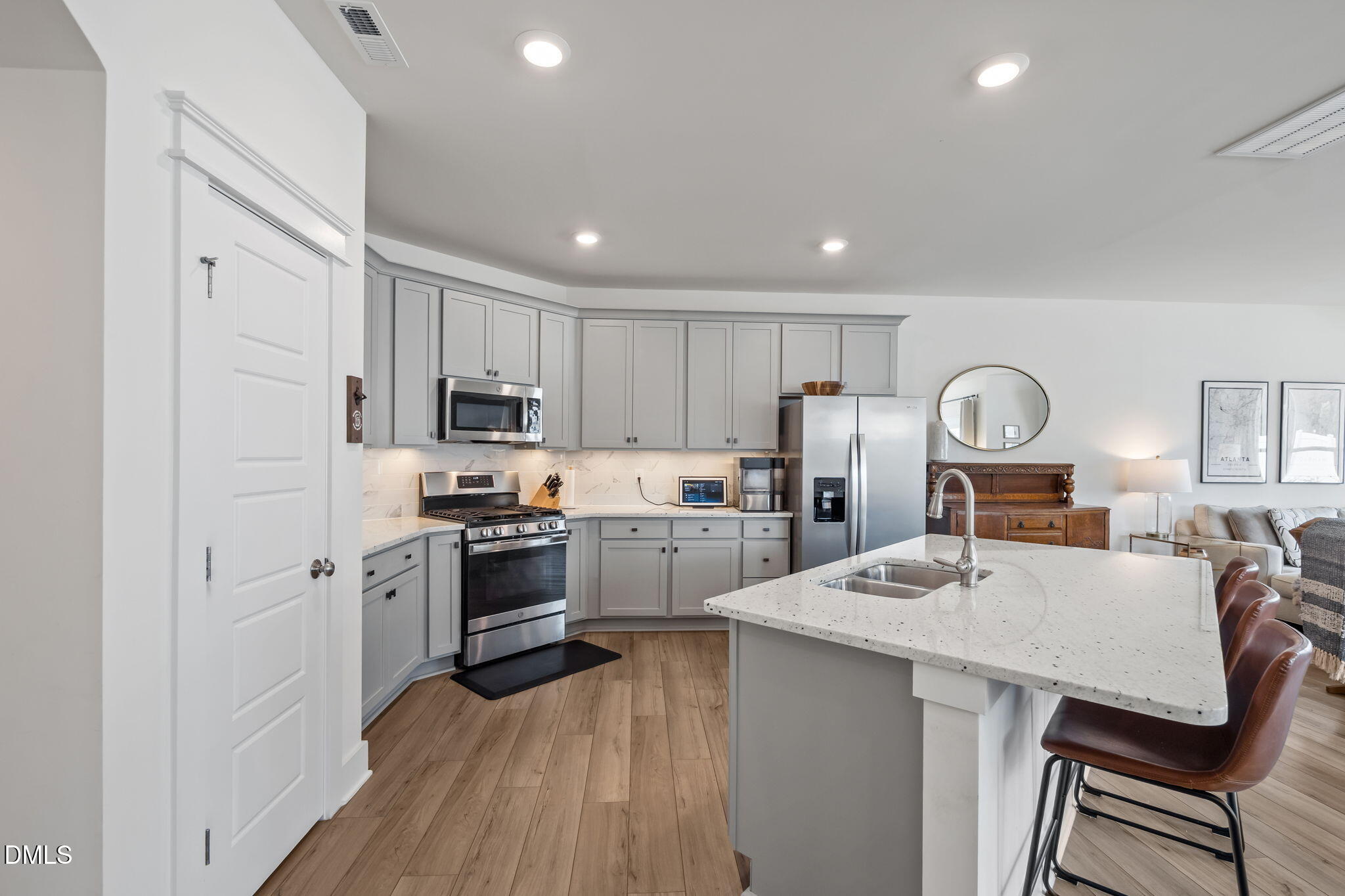 1000 Heartstone Way Durham, NC 27713 - Photo 10 of 43 a kitchen with cabinets a counter and stainless steel appliances