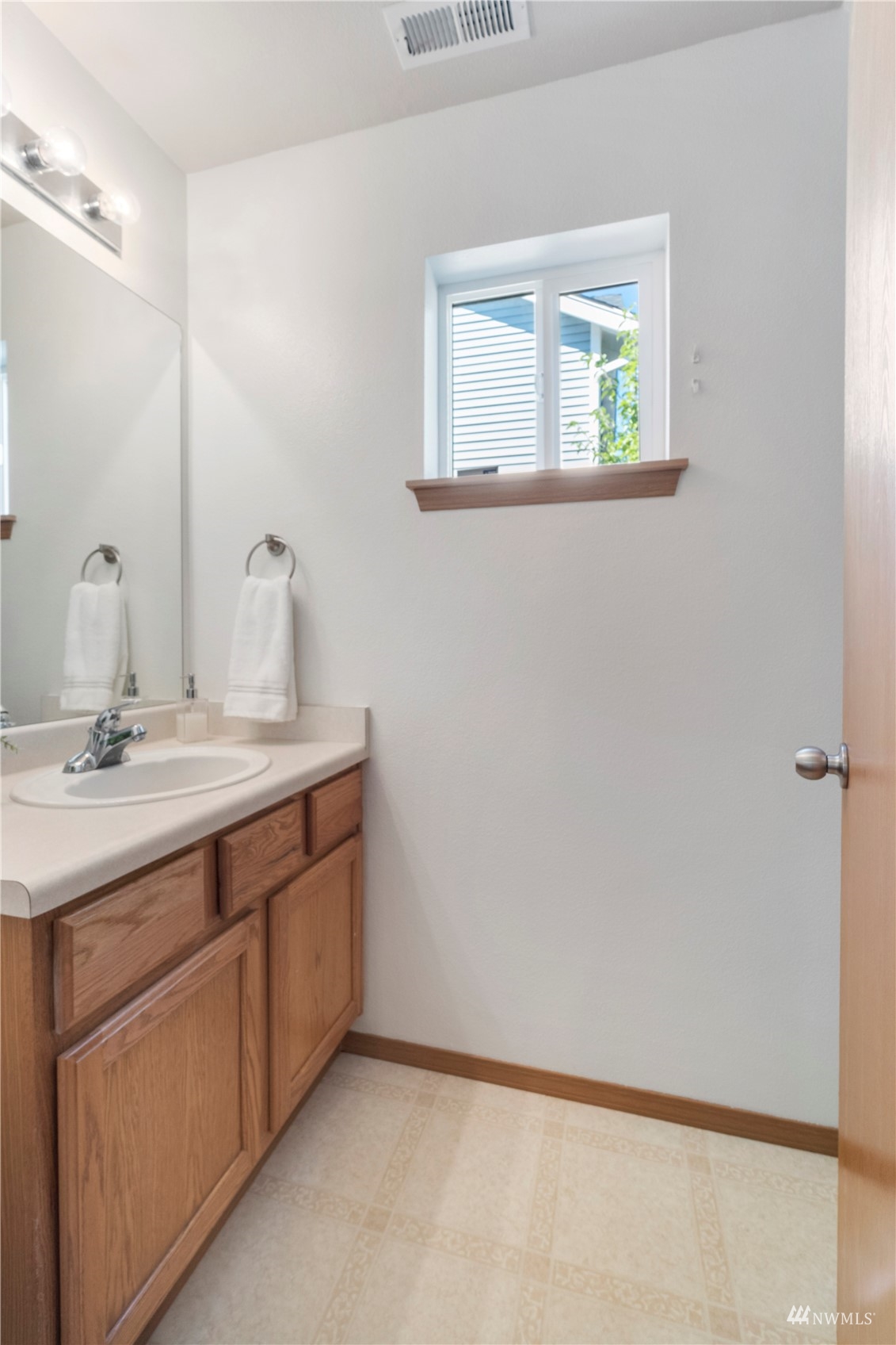 3118 Walker Road DuPont, WA 98327 - Photo 14 of 33 a bathroom with a double vanity sink and a window
