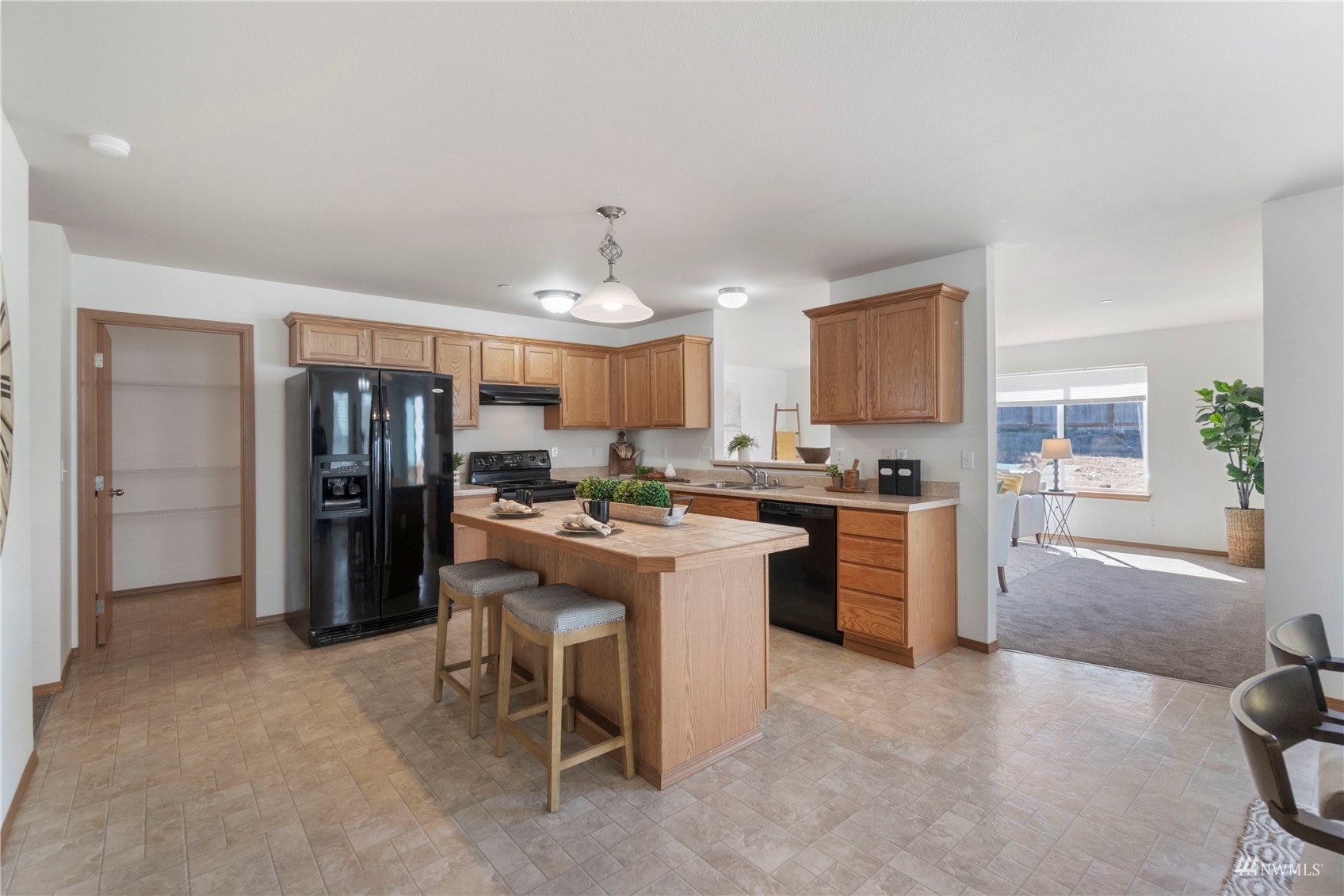 3118 Walker Road DuPont, WA 98327 - Photo 7 of 33 a kitchen with refrigerator and cabinets