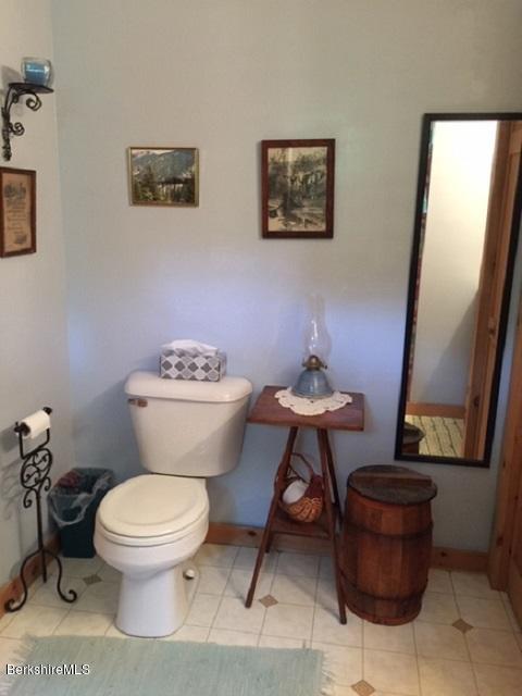 2810 Howe Pond Road Readsboro, VT 05350 - Photo 15 of 29 a bathroom with a toilet a sink and a mirror