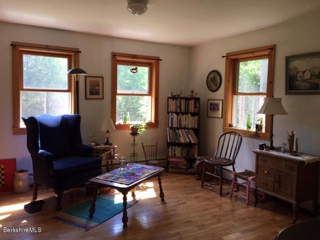 2810 Howe Pond Road Readsboro, VT 05350 - Photo 19 of 29 a living room with furniture a window and a flat screen tv