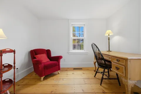 a workspace room with furniture and windows