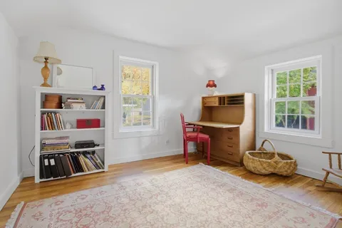 a bedroom with furniture and a window