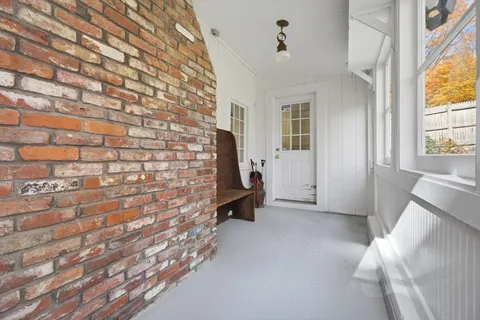 a view of entryway with window and wooden floor