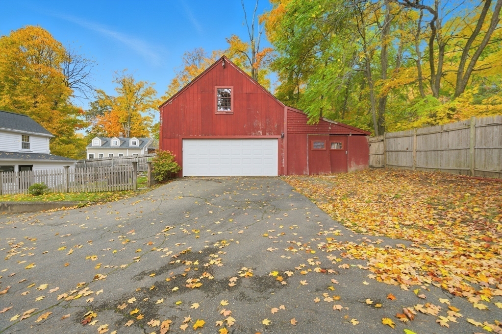 36 Concord Road Sudbury, MA 01776 - Photo 24 of 30 a front view of a house with a yard and garage