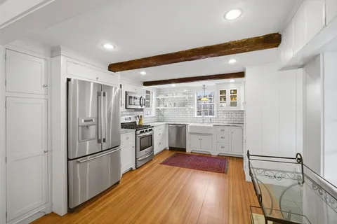 a kitchen with stainless steel appliances a refrigerator and a stove top oven