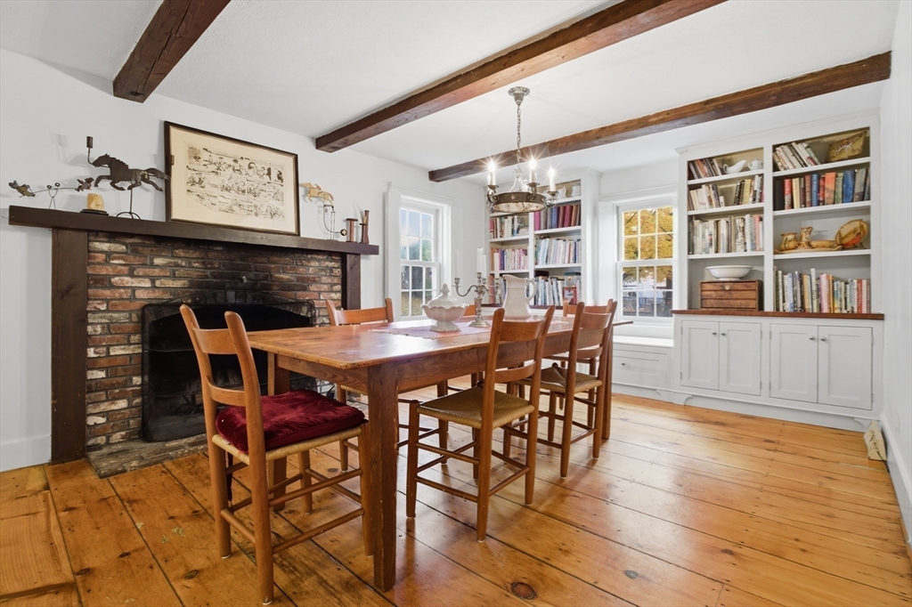 36 Concord Road Sudbury, MA 01776 - Photo 7 of 30 a dining room with a wooden table and chairs