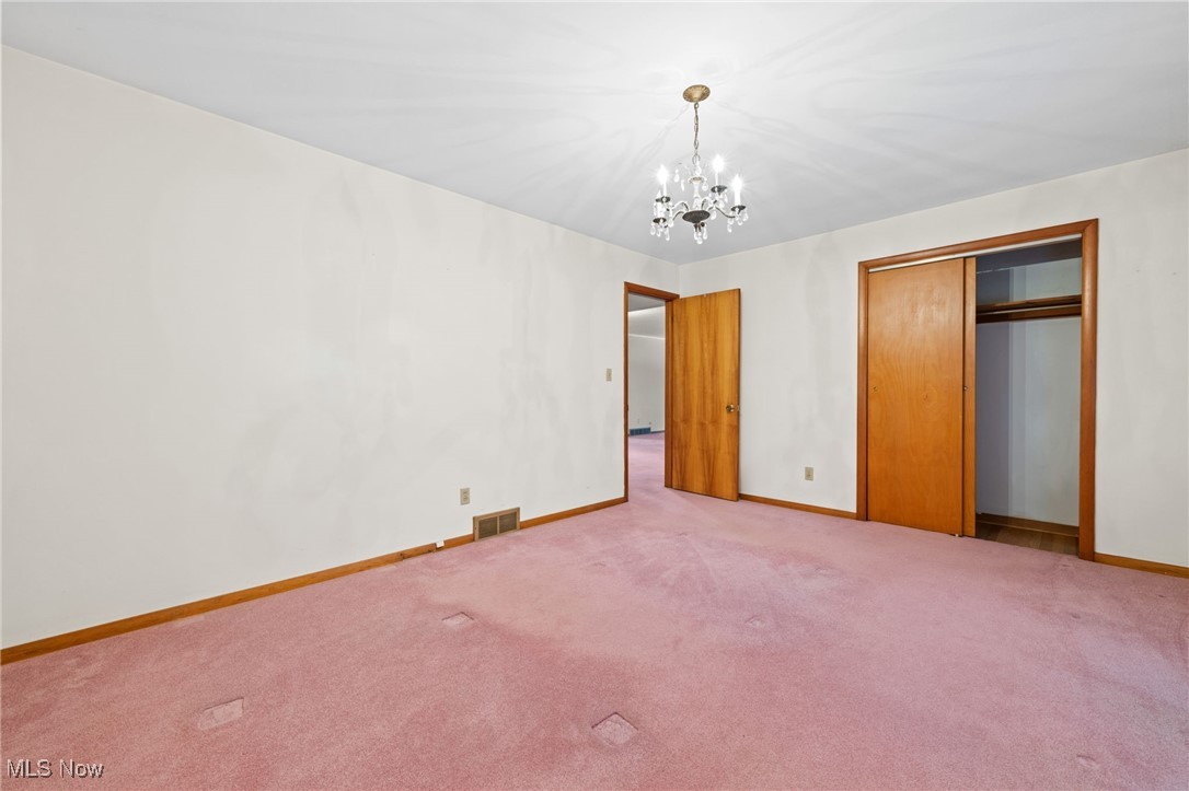 586 Bishop Road Cleveland, OH 44143 - Photo 15 of 24 Unfurnished bedroom featuring a chandelier, visible vents, light carpet, and baseboards